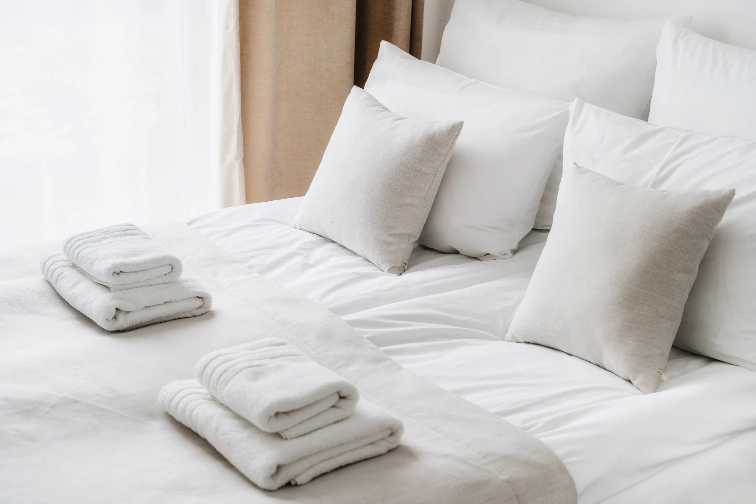 Luxury mountain chalet bedroom with pristine white linens
